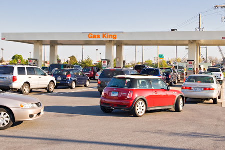 Cars lined up to refuel with gasoline.